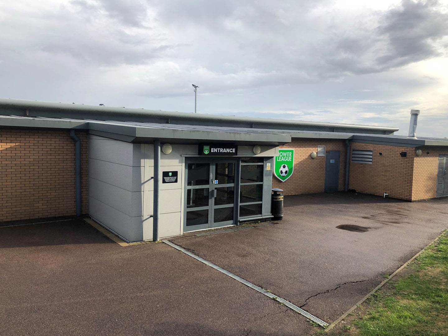 The exterior of this single-story building features a glass entrance door marked 