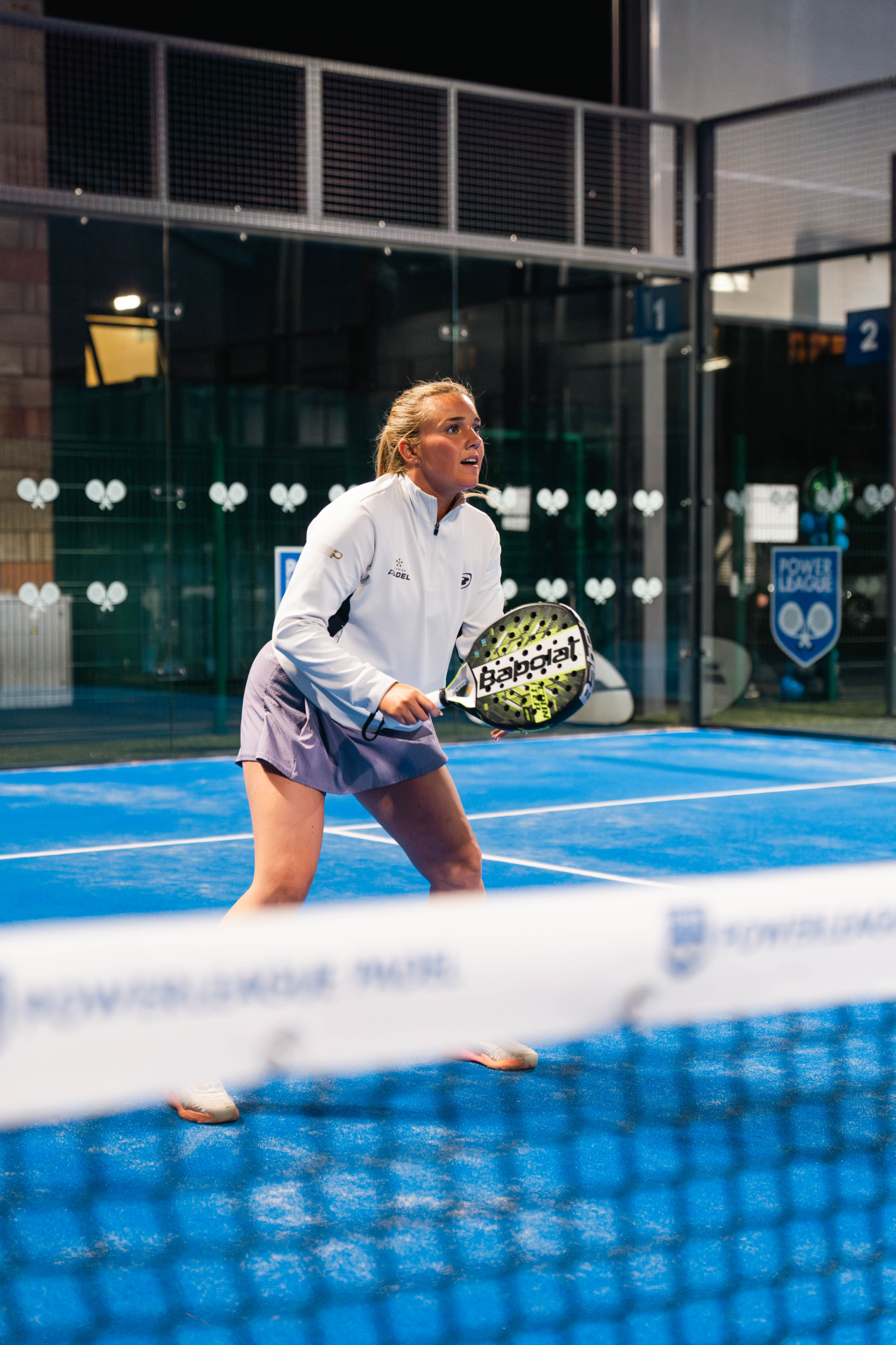 woman holding racket during a padel match.
