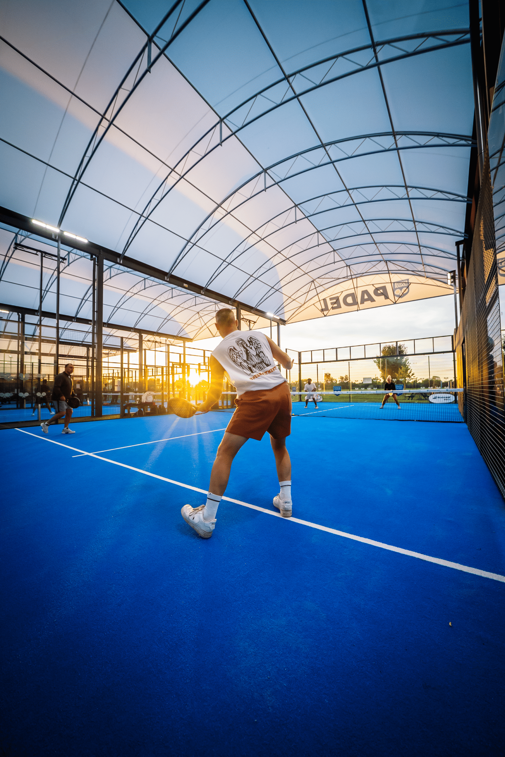 Returning a padel shot at Powerleague padel in Mill Hill
