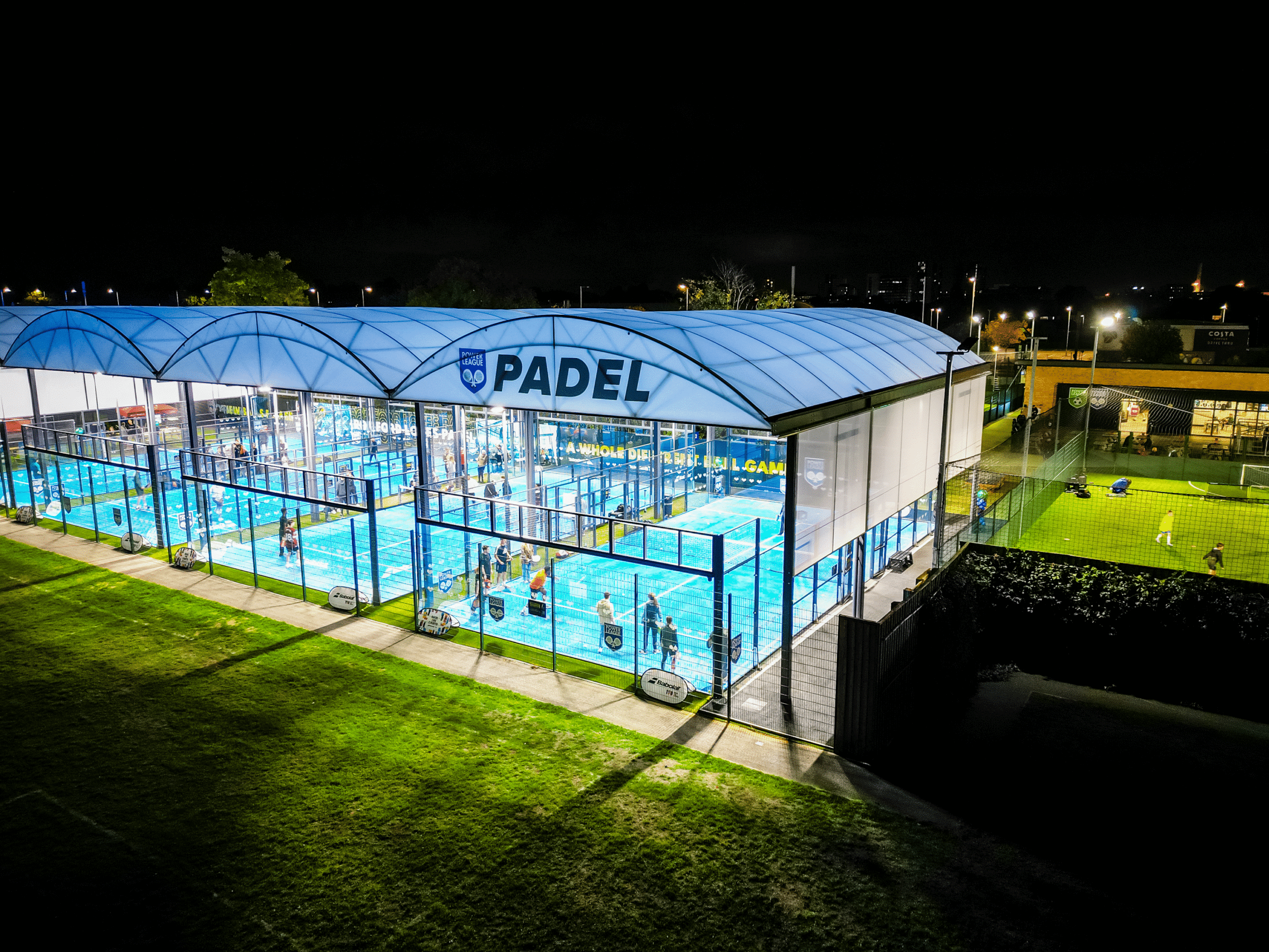 a night time view of Powerleague Romford's padel courts.