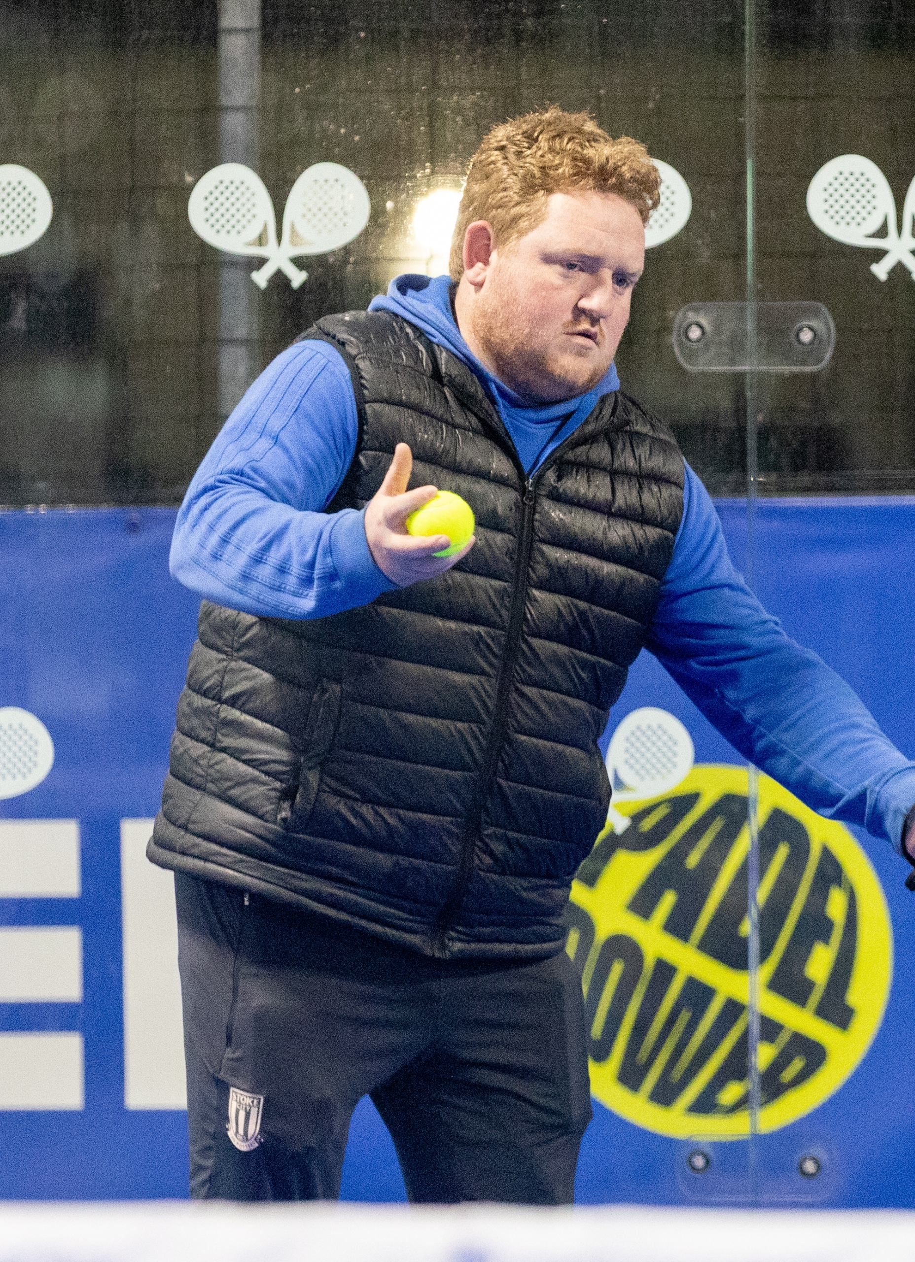 Person with a padel ball in their hand at Stoke.